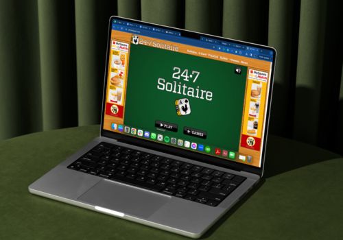 A laptop screen with an open 247 Solitaire website screen